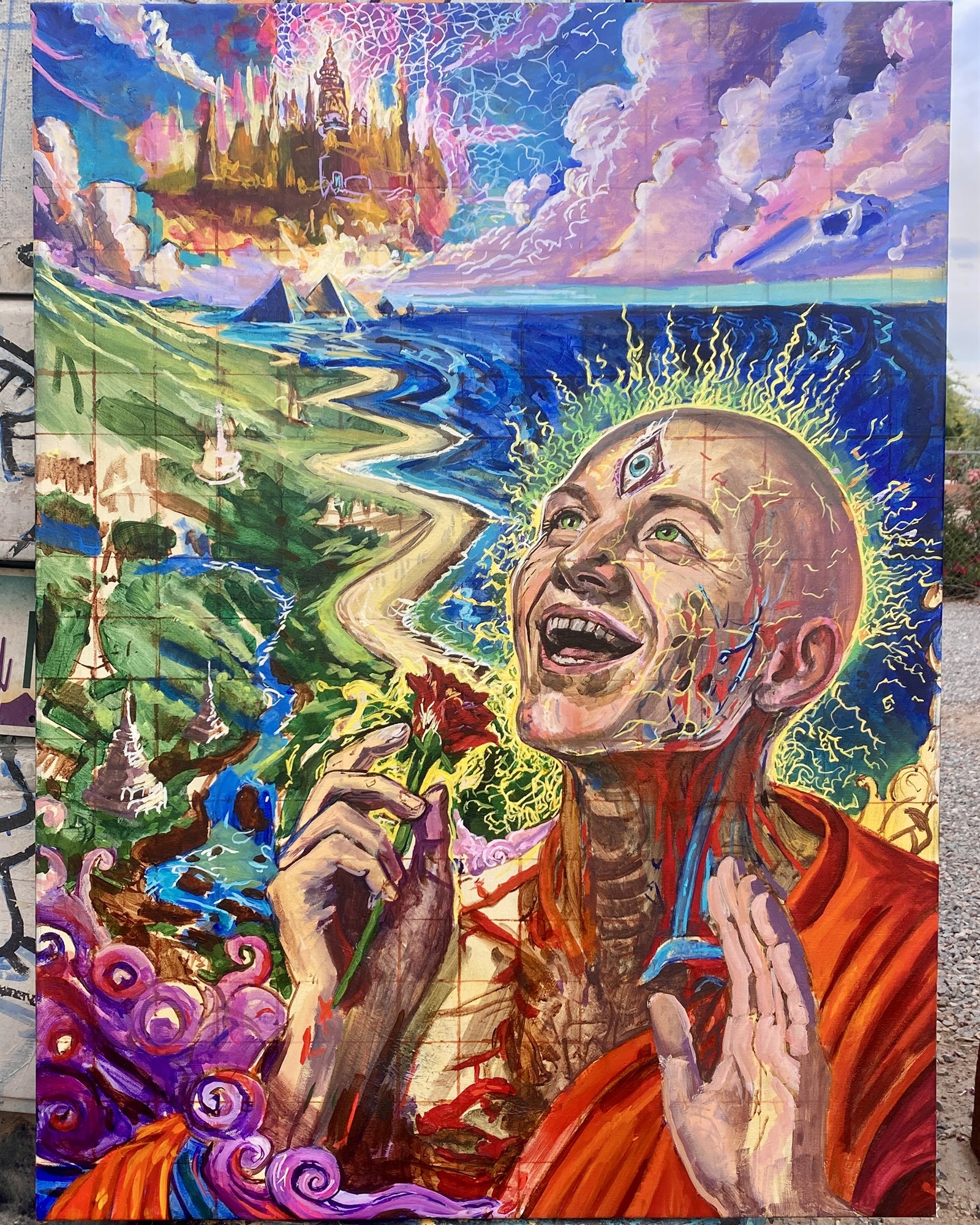 Large colorful painting with a radiant figure, coastline, ocean, clouds, and imagined architecture.
